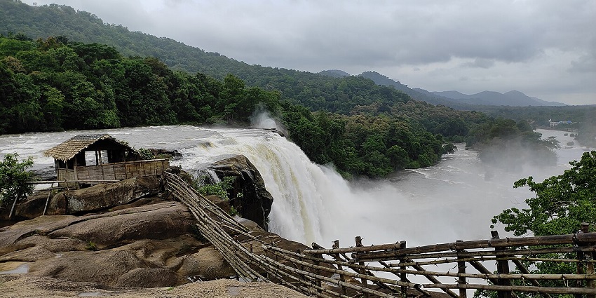 Athirappilly Waterfalls in Kerala cascading powerfully through rocks and dense greenery
