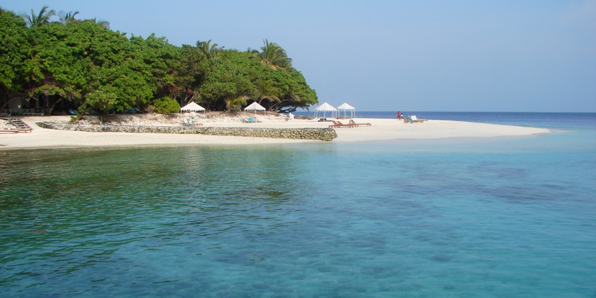 A picture of a beautiful beach with golden sands and views of serene blue waters