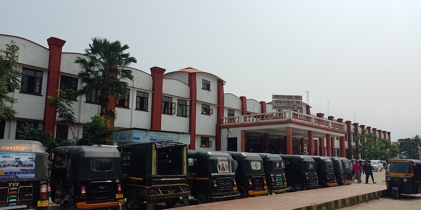 Front view of Badarpur Railway Station with its iconic facade and bustling activity.