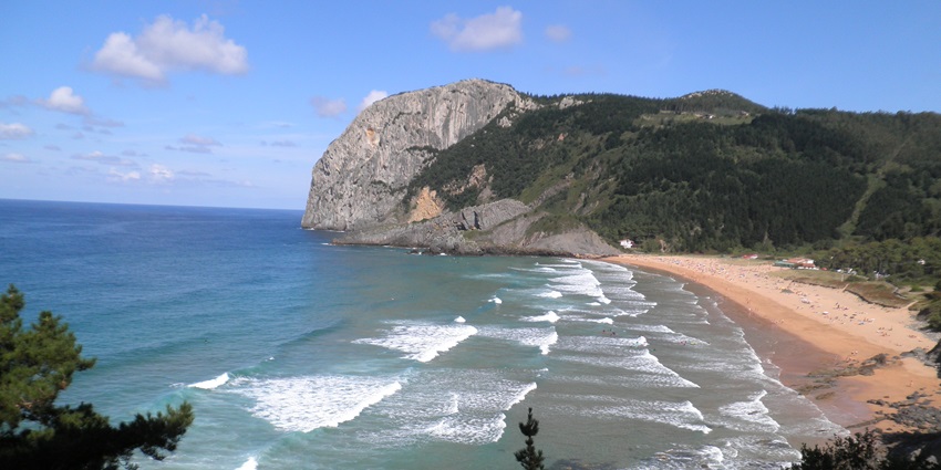 An aerial view of frothy waves hitting the pristine sands of Bai Dai in the region