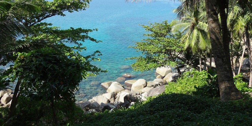 Cobalt blue waters of Bamboo Bay, one of the picturesque Koh Lanta beaches in Thailand.