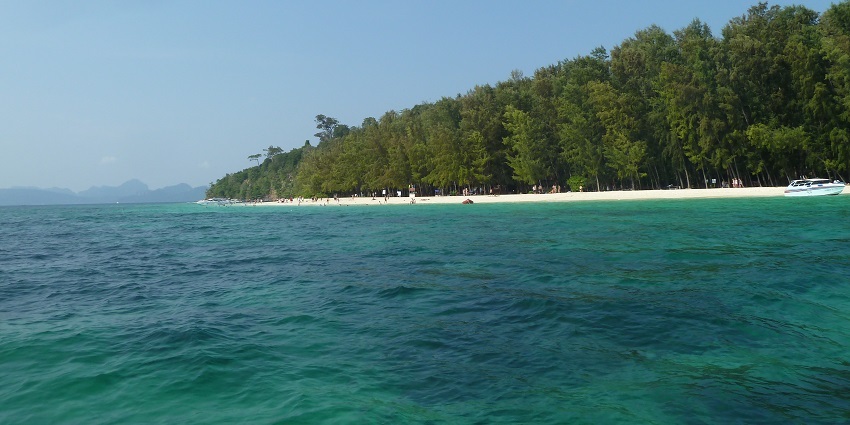 A picture of an island taken from far away showing the vast ocean around