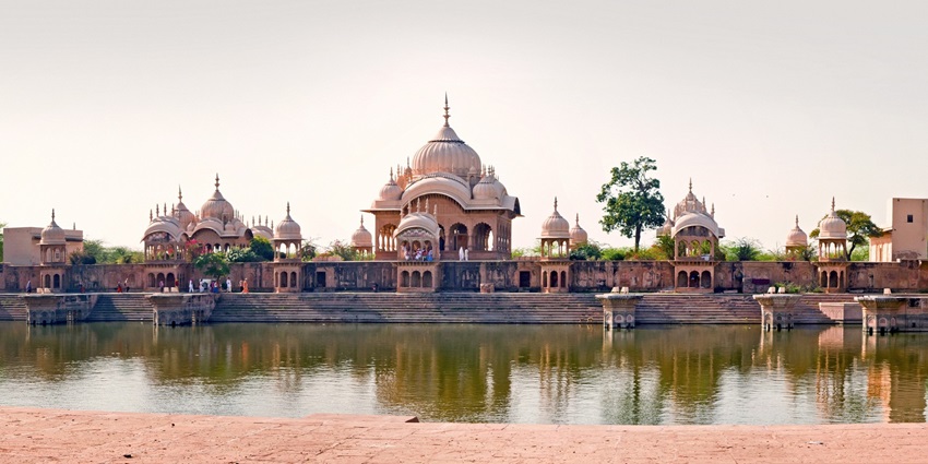 A view of the historical Bangalpukhari tank in Jorhat, Assam, surrounded by greenery and a tranquil setting.