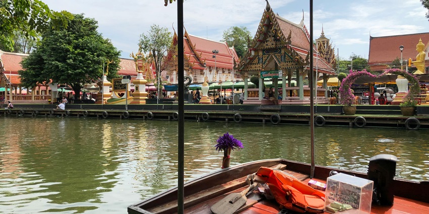 Image of Scenic View of Ancient Thai Temple from a Boat - places to visit in thailand in August