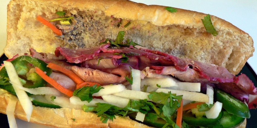 Banh Mi, one of the best street foods in Guwahati, consists of a crusty baguette filled with meat.