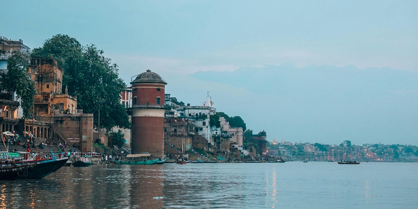 Scenic image of the holy bank of a river and the buildings around it in India