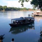 Scenic view of calm Barak river and people around - Places to visit in Silchar.