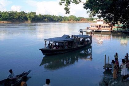 Scenic view of calm Barak river and people around - Places to visit in Silchar.