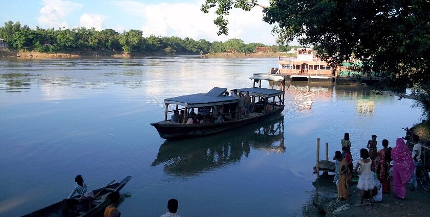 Scenic view of calm Barak river and people around - Places to visit in Silchar.