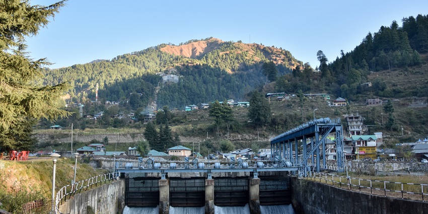 Uhl Barrage in Himachal Pradesh, showcasing beautiful mountains and vibrant greenery.