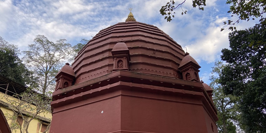 Basistha Temple view with its traditional architecture, surrounded by lush greenery.