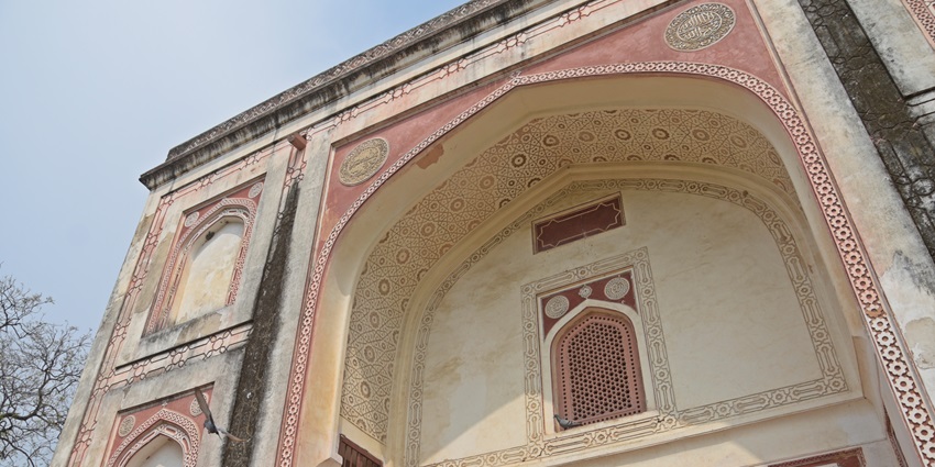 Bara Batashewala Tomb with domed roof and arched façade in a green setting.