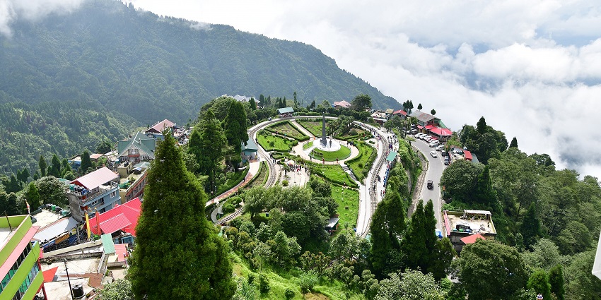 A serene view of Batasia Loop featuring a majestic peak decked with lush greenery.