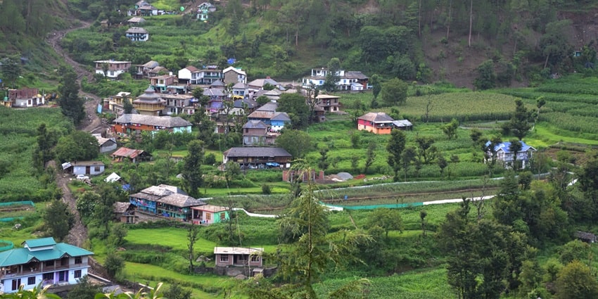 Batheri Village in Mandi with traditional Himachali houses, terraced fields, and scenic mountain views.