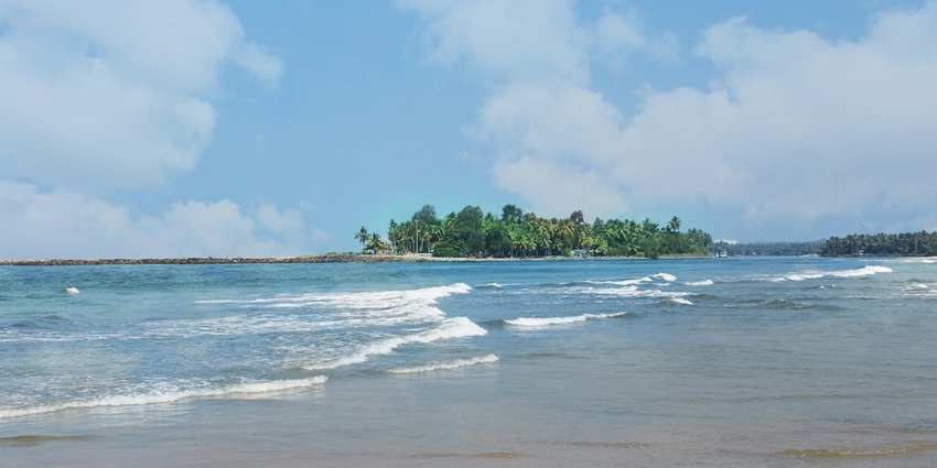 Explore the crystal-clear waters of the Arabian Sea from the pristine Chembirika Beach