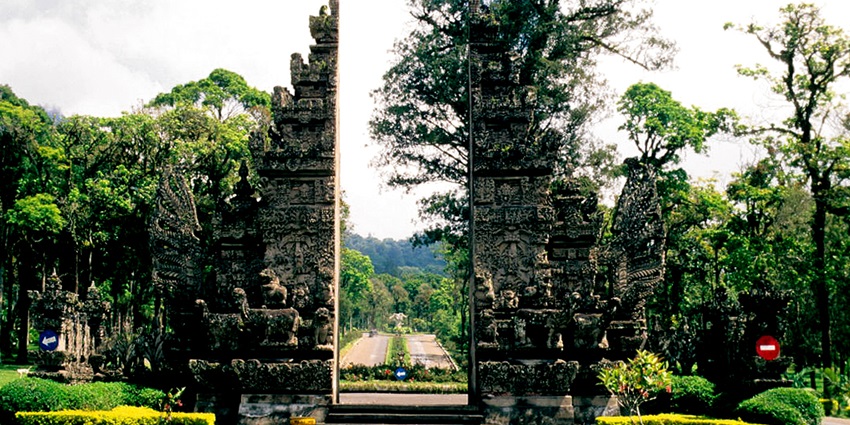 Traditional Balinese doorway (bentar) within the lush Bali Botanic Garden Bedugul