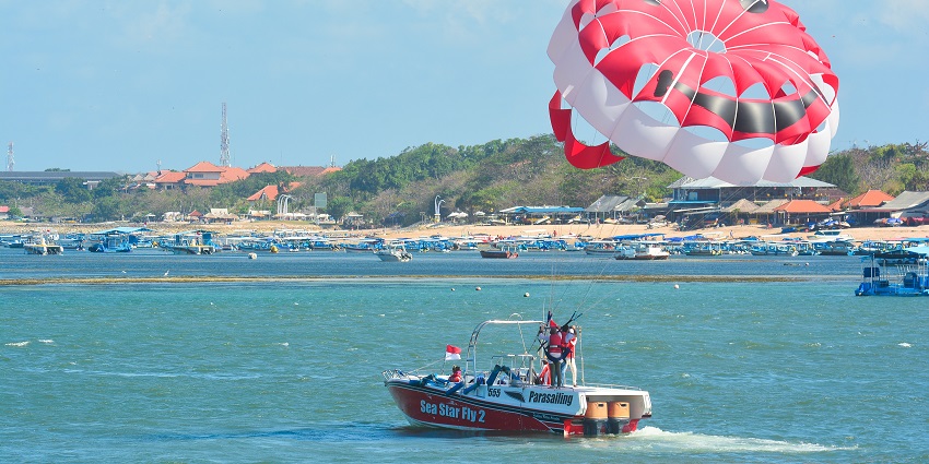Benoa Beach offers plenty of water sports like jet skiing and parasailing in Indonesia