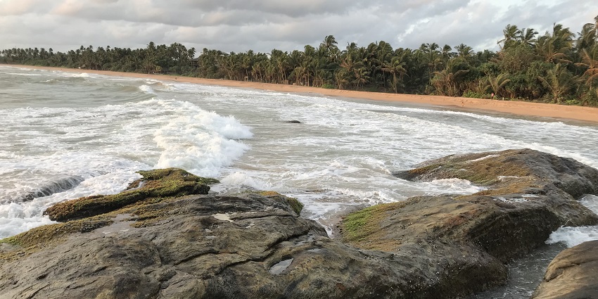 Bentota Beach in Sri Lanka with golden sands, clear turquoise waters, and a coastal.
