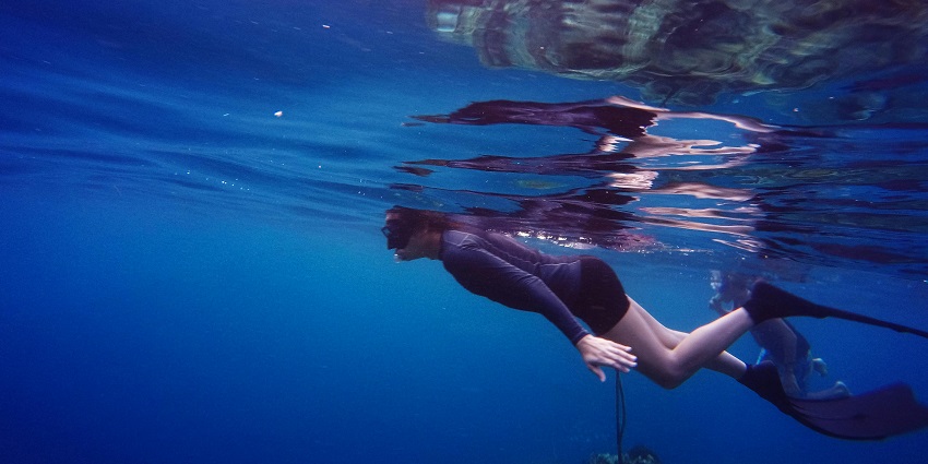 A picture of a woman snorkelling in Bali and exploring the underwater world