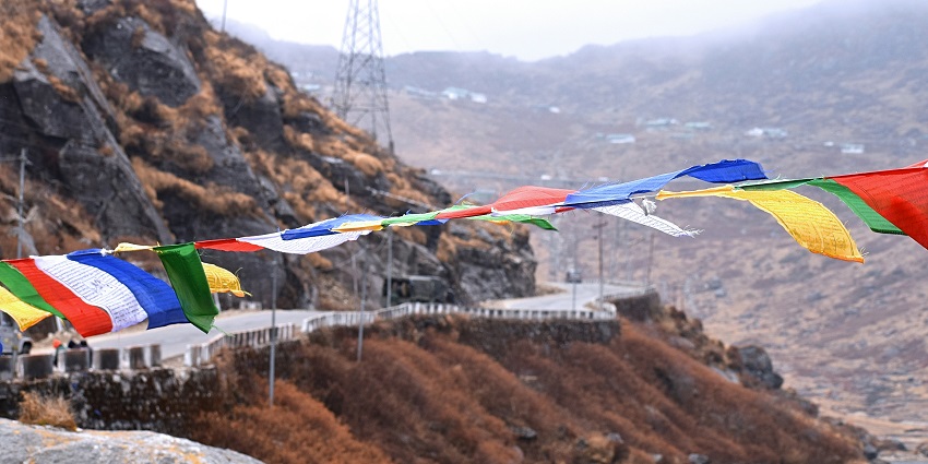 A mesmerising view of different colourful flags over a body of water in Gangtok