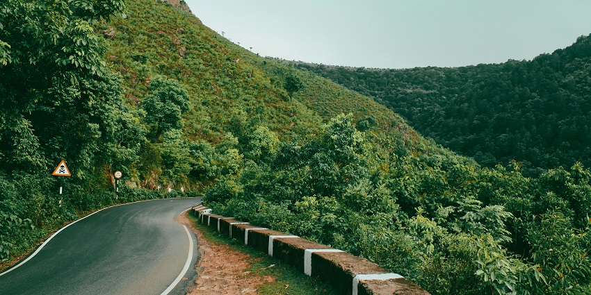A stunning view of a city in Andhra Pradesh with lush greenery all around during the day.