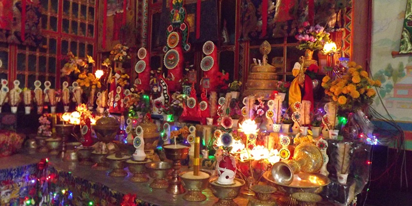 An inside view of the monastery with colourful lamps and lights with a vibrant background.