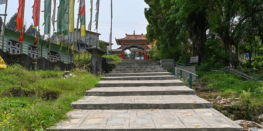 A view of steps leading up to a monastery in Sikkim with colourful architecture.