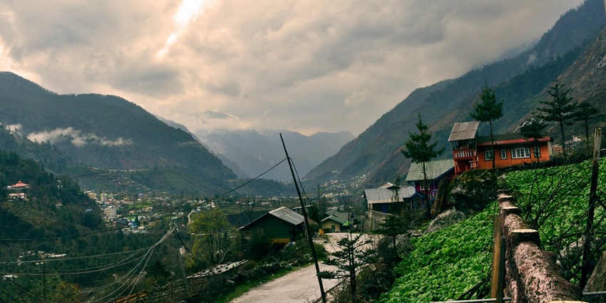 A stunning view of Gangtok with lush green mountains in the backdrop during the day.