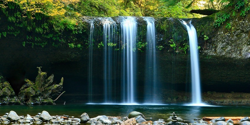 A glimpse of glistening waters pouring down the majestic peaks and meeting the river.