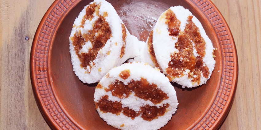 Bhapa Pitha, a traditional steamed cake, enjoyed during the harvest festival of Assam.