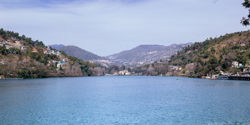 A picture of the enchanting Bhimtal Lake with serene views of blue waters at offer