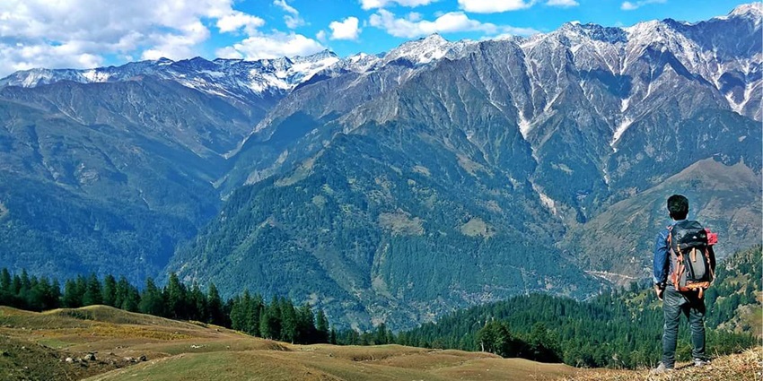 A picture of the majestic Himalayan range from Bhrigu Lake, surrounded by lush green mountains