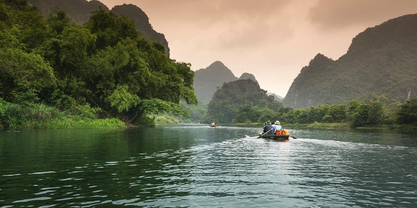 Beautiful image of boat riding amidst jungle—Things to do in Maldives for couples