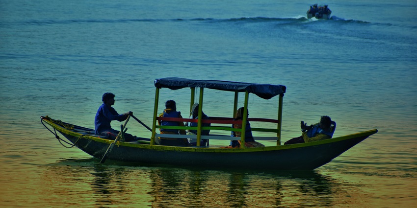 Image of a boat and travellers exploring the late - one of the best things to do in Sissu