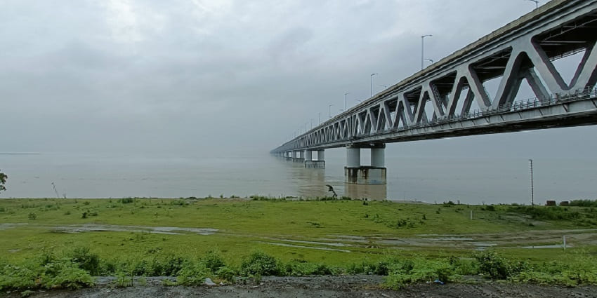A serene view of the Bogibeel Bridge Area featuring lush green vegetation and more.