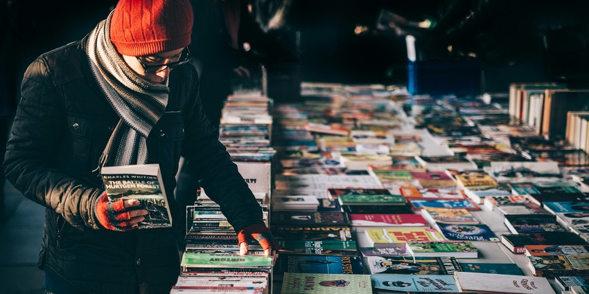 A man is checking out book in a store in the Khan maket book stalls in Delhi