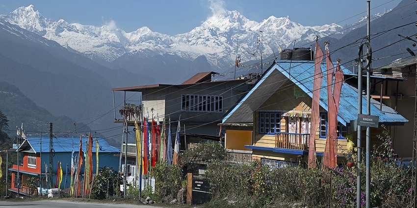 A serene mountain village road in North Sikkim, set against a dramatic backdrop