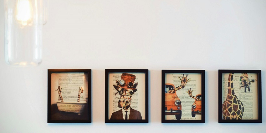 A picture of a white wall from an art gallery in Guwahati having multiple paintings hung