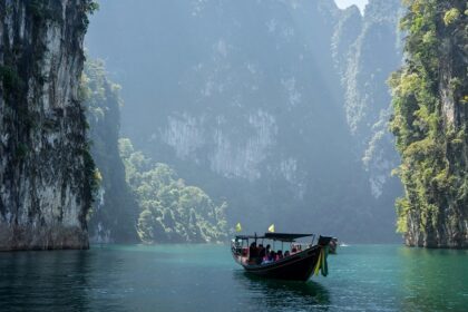 A scenic view of people enjoying a boat ride at the Khao Sok National Park, Thailand.