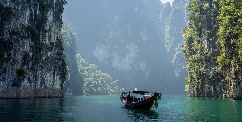 A scenic view of people enjoying a boat ride at the Khao Sok National Park, Thailand.