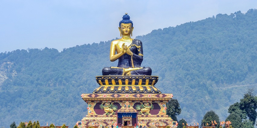 A tall Buddha statue at a park near the Bon Monastery