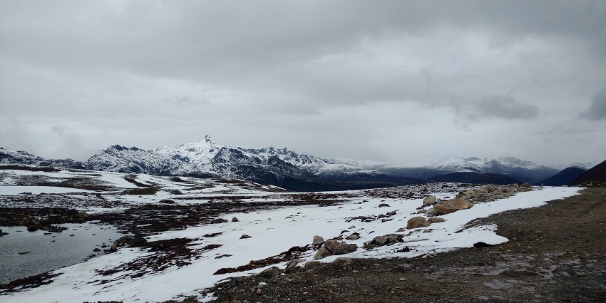 Panoramic view of the snow covered landscapes of Bumla pass overlooking the hills