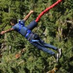 Snapshot of a man during the Bungee jumping Bali, freom a desgianated spot in forest.