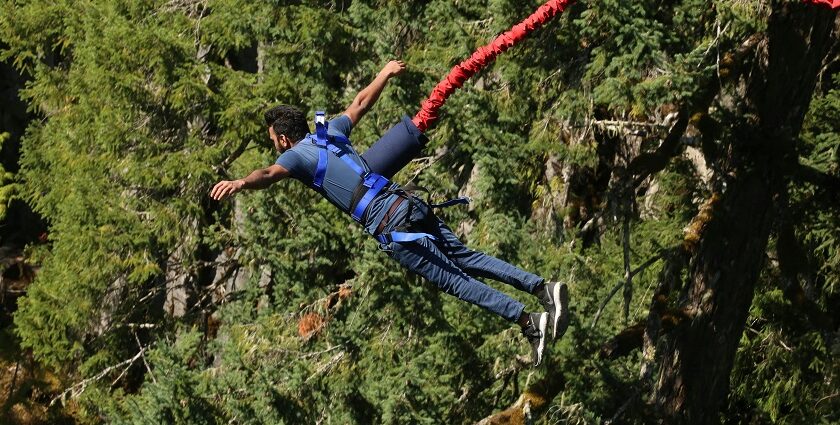 Snapshot of a man during the Bungee jumping Bali, freom a desgianated spot in forest.