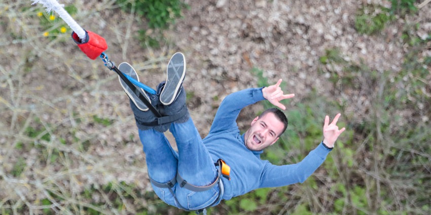 Snapshot of a man Bungee Jumping somewhere in the Dubai–Bungee Jumping In Dubai