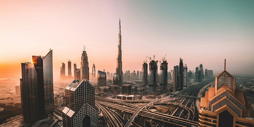 Evening view of Dubai Downtown and the skyscraping Burj Khalifa with sunset in backdrop