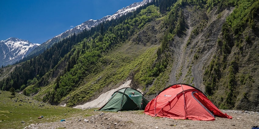 Red and Green Tents near lush green and snow coverd Mountains - Camping in Sonmarg