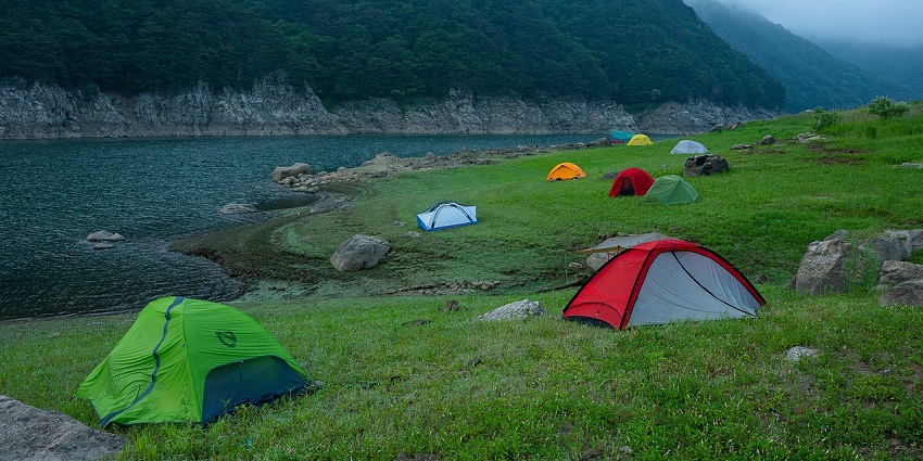 Camping in Puri at Chilika Lake offers misty mornings to golden sunsets reflecting off the calm waters.