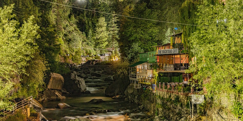 Mesmersing view of a stream of water passing through a canal surrounded by lush trees