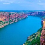 A stunning view of Gandikota Canyon in Andhra Pradesh, showcasing its rocky cliffs and lush greenery.